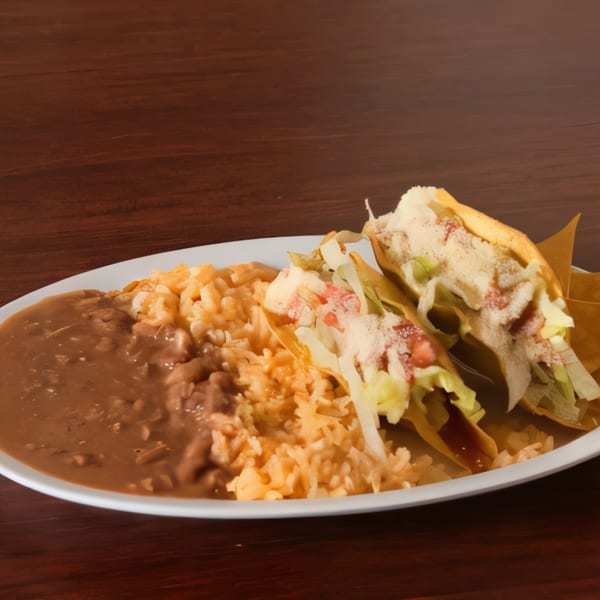 Two Super Burrito & Taqueria tacos with lettuce, tomato, and cheese, served with rice and refried beans.
